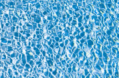 rippled water backdrop blue color in summer swimming pool.