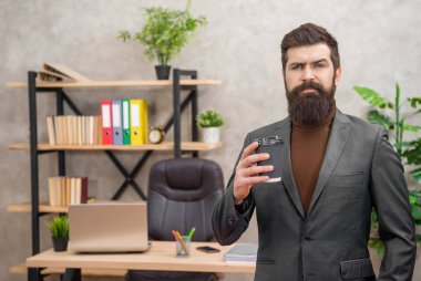 serious mature entrepreneur in jacket having coffee break in paper cup, guy.