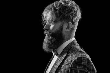 profile of formal man in menswear on background. photo of formal man in menswear with beard. formal man in menswear isolated on black. formal man in menswear at studio.