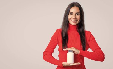 woman with vitamin medication isolated on white, copy space. woman with vitamin medication in studio. woman with vitamin medication on background. photo of woman with vitamin medication jar.