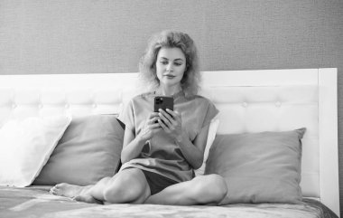 girl relax at home and texting on phone. girl texting on phone on the bed. phone texting of girl.