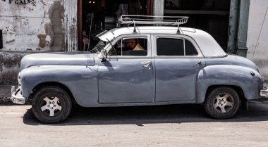 Havana, Cuba - May 02, 2019: classic old timer car pontiac with driver man.