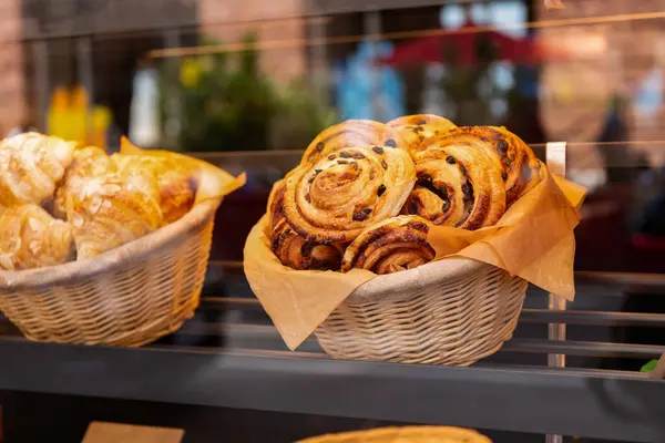fresh baked cinnabon. french croissant pastry. fresh bakery. cinnabon croissant in basket. baked food. breakfast in cafe with cinnabon or croissant. bakery food in basket.