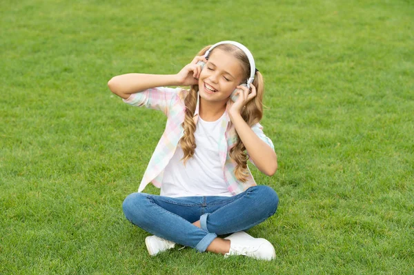 teen girl listen to music. carefree and happy childhood. lifestyle of teen girl. music of her childhood. listening to music in headphones outdoor. teen girl listen a song in wireless headphones.