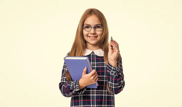 photo of smiling school girl reader hold diary. school girl reader with diary isolated on white background. school girl reader hold diary in studio. school girl reader holding diary.