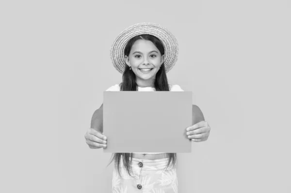 stock image happy teen girl with copy space on orange paper on yellow background.