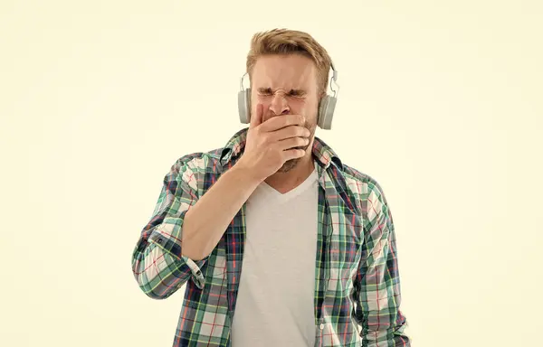 yawning man listen music on background. man listen music in studio. photo of man listen music. man listen music isolated on white.