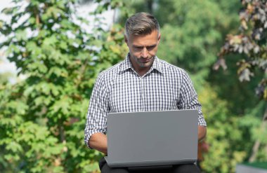 busy man working on laptop. man freelancer outdoor. business man with pc.