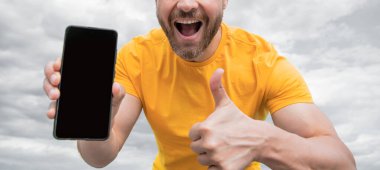 cropped view of guy presenting smartphone screen with copy space.