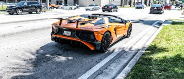 Miami Beach, Florida USA - April 15, 2021: orange Lamborghini Aventador LP 750-4 SV, back view.