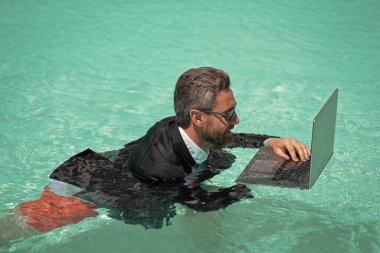 Mutlu adamın hafta sonu laptopla iş görüşmesi var. Bir adamın fotoğrafı iş için hafta sonu aranıyormuş. Adamın hafta sonu iş görüşmesi var. Adamın hafta sonu iş görüşmeleri var.