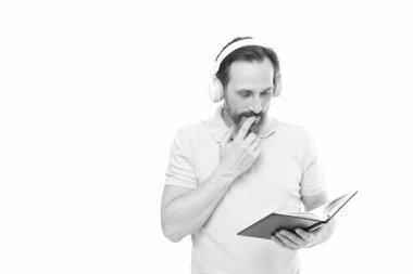 man reading elearning in headphones, copy space. man reading elearning in headphones on background. photo of man reading elearning in headphones. man reading elearning in headphones isolated on white.