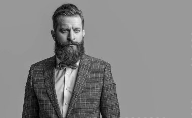 tuxedo formal man in studio advertisement. tuxedo formal man on background. photo of tuxedo formal man with beard. tuxedo formal man isolated on grey.