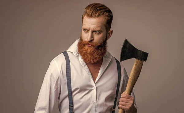 stock image caucasian brutal man with axe on background. photo of brutal man with axe. brutal man with axe isolated on grey. brutal man with axe in studio.