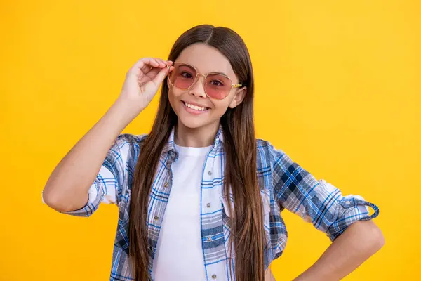 stock image Young teen girl standing in sunglasses. Beautiful teen girl wearing checkered shirt. teen girl with long hair. teen girl in casual style. summertime trends.