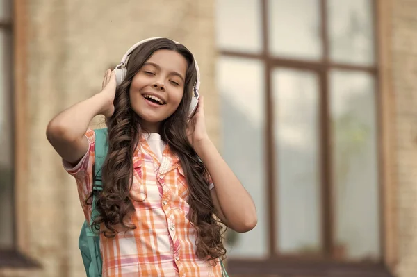 photo of school girl listen music, advertisement. school girl listen music. school girl listen music outdoor. school girl listen music outside.