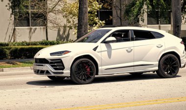 Miami Beach, Florida USA - April 15, 2021: 2019 Giallo Auge Lamborghini Urus, side view.