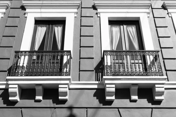photo of balcony railings on windows. balcony railings on house. balcony railings facade. balcony railings outdoor.