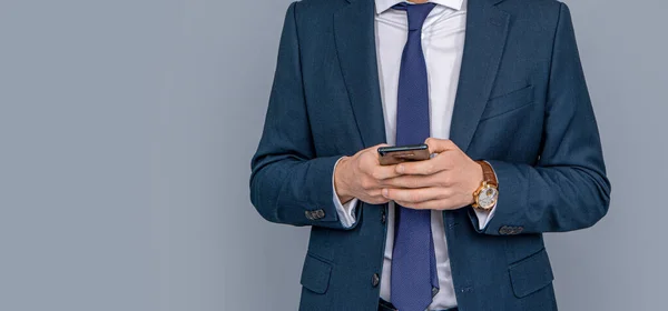 Man phone conversation in studio. Young business man with phone. Business communication. Casual business man chatting on phone isolated on grey. Businessman using phone. copy space banner.