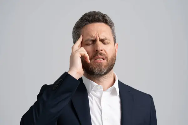 Business man got migraine touch head because of pain. Headache and strain. Headache, tiredness and stress. Businessman in suit has headache. Businessman with stress and burnout. Professional Pressure.