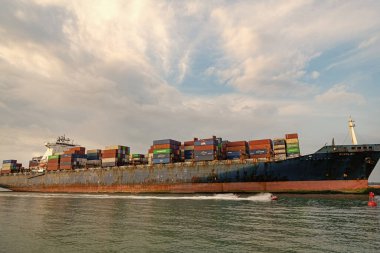 Miami Beach, Florida USA - April 18, 2021: cargo ship tanker with containers in port.