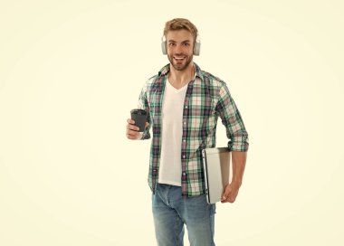 Milenyum erkek öğrencisi kahvesini beyaz üzerine izole etmiş. Bin yıllık erkek öğrenci arka planda. Stüdyoda bin yıllık öğrenci. Dizüstü bilgisayarı olan bin yıllık öğrencinin fotoğrafı..