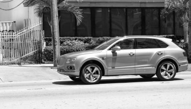 Miami Beach, Florida USA - April 15, 2021: pink Bentley Bentayga v8 2015 modern suv, front side view.