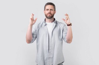 wishing man make wish with raised finger. wishing man make wish isolated on grey background. wishing man make wish in studio. photo of wishing man make wish.