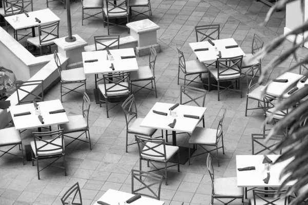 Empty outdoor cafe or restarant. Cafe restaurant furniture set in patio terrace backyard. Cafe restaurant tables with chairs. Outdoor cafe restaurant viewed from above.
