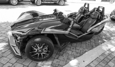 Miami Beach, Florida USA - April 15, 2021: blue orange polaris slingshot, top view. three-wheeled motorcycle.