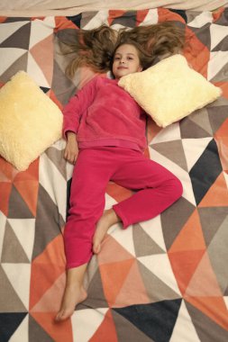 childhood of teen girl relax in bed, full length. childhood of teen girl relax in bedroom. childhood of teen girl relax wearing pajama. childhood of teen girl relax.