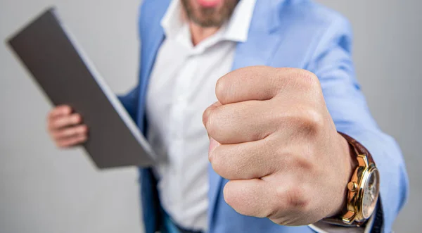 Anger management. Angry and aggressive man threatening with fist. Angry businessman, selective focus. Businessman hold laptop and threatening with fist. Business boss man feel anger and aggression.
