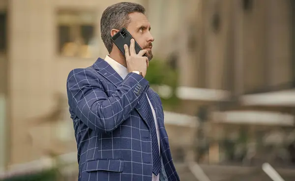 businessman call on phone outside, copy space. communication businessman call on phone and talk. businessman has phone call outdoor. businessman having phone call in the street.