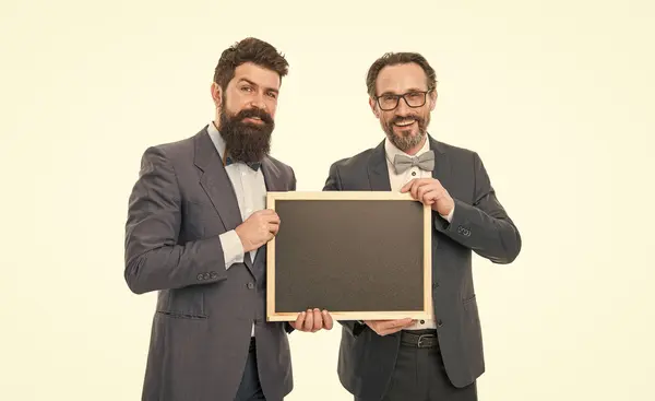 welcome on board. businessmen in suit, copy space. announcement. party invitation. partners celebrate start up business isolated on white. bearded men hold advertisement blackboard. happy businessmen.