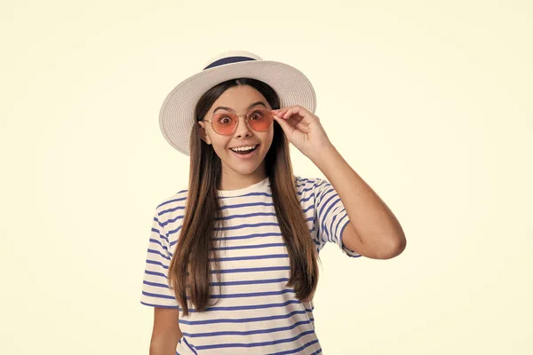 stock image summer trendy amazed teen girl on background. summer trendy teen girl in studio. summer trendy teen girl wearing hat. summer trendy teen girl isolated on white.