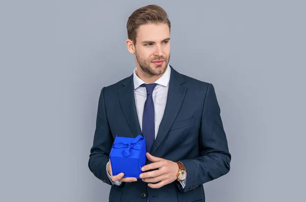 Corporate present. Mens day. Successful boss share gift box. Businessman prepare for romance date. Business reward. Business man with corporate gift box isolated on grey. Getting clients interested.