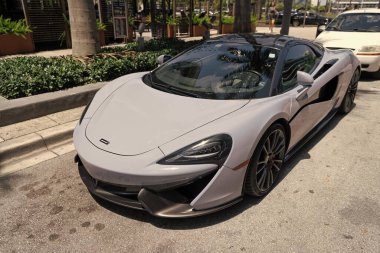 Miami Beach, Florida ABD - 15 Nisan 2021: beyaz Mclaren 570 üstü açık spor araba, köşe manzaralı.