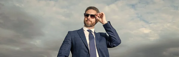 professional man in suit outdoor. man in business suit. photo of man in suit. man in suit on sky background.