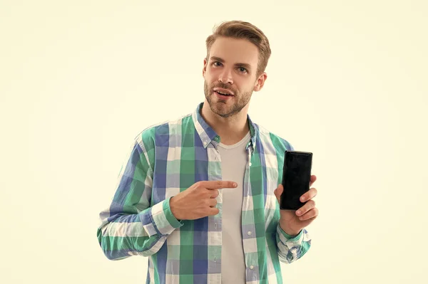 man showing phone screen on background, pointing finger. photo of man presenting phone screen. man with phone screen isolated on white. man shows phone screen in studio.