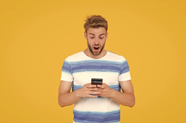 digital communication of surprised man with phone. man uses his phone to text making communication easy and convenient. man uses phone to make effective communication. man has phone communication.