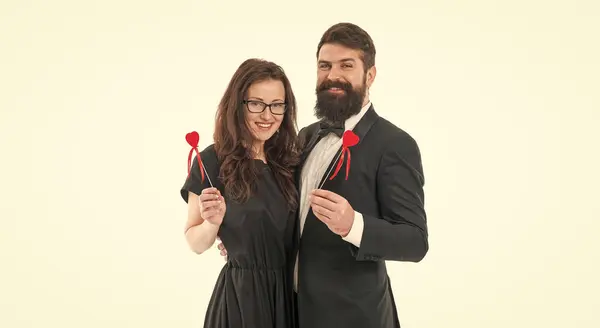 Honeymoon. tuxedo man beard. business lady in glasses. formal couple in love hold heart. elegant couple formal event party. love and romance. romantic date for man and woman. happy valentines day.