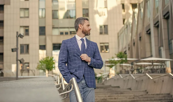 businessman walk outdoor. businessman on urban background. businessman wearing jacket in the street. photo of businessman with tie.