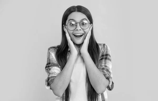 stock image amazed teenager girl on background. photo of teenager girl with long hair wearing glasses. teenager girl isolated on yellow. teenager girl in studio.