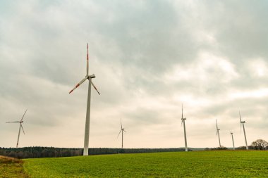 Yel değirmeni türbinleri ile enerji ve elektrik üreten yeşil enerji kavramı.