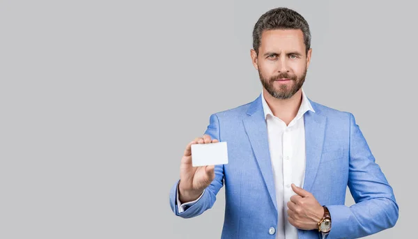 stock image businessman in suit hold credit card isolated on grey. Business branding. Pay the bill. businessman with credit card in studio. Business deal with emoney. Success of business. copy space banner.