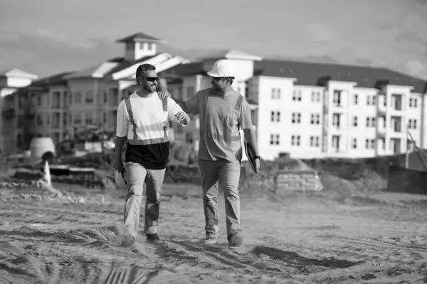 image of engineer men at construction site. engineer men at construction site. engineer men at construction site wearing hardhat. engineer men at construction site outdoor.