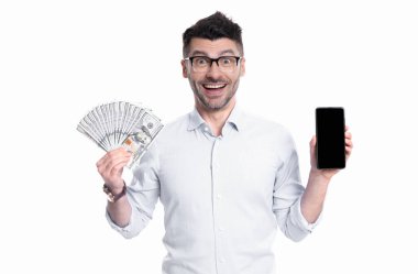 Happy man showing cash money and smartphone studio. Cash payment or smartphone payment. Cash purchase. Paying in cash for smartphone.