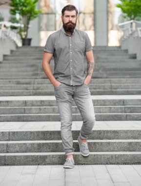 bearded man walk downstairs. full length of man with beard. hipster man outdoor.