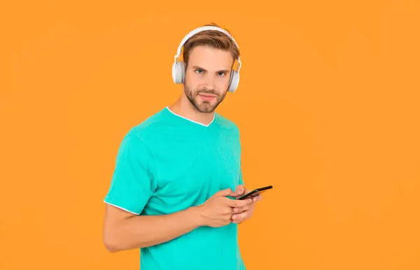 You are what you listen to. Guy listen to mobile music. Listening to playlist with headphones. Music smartphone. Stay tuned.