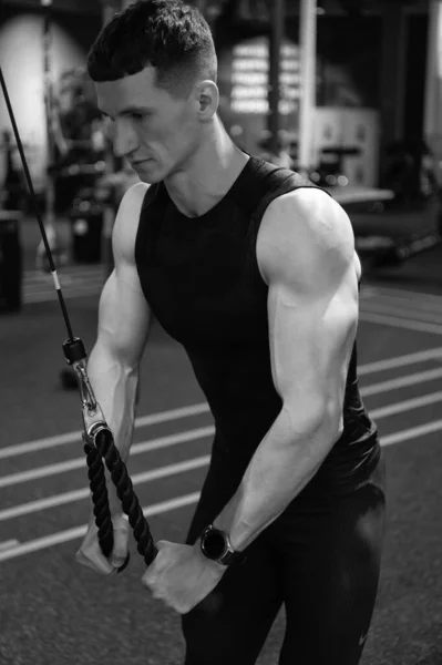 sport muscular man do weightlifting in fitness gym. weightlifting practicing muscular man in gym. sport and fitness. weightlifting muscular man practicing sport in fitness gym.
